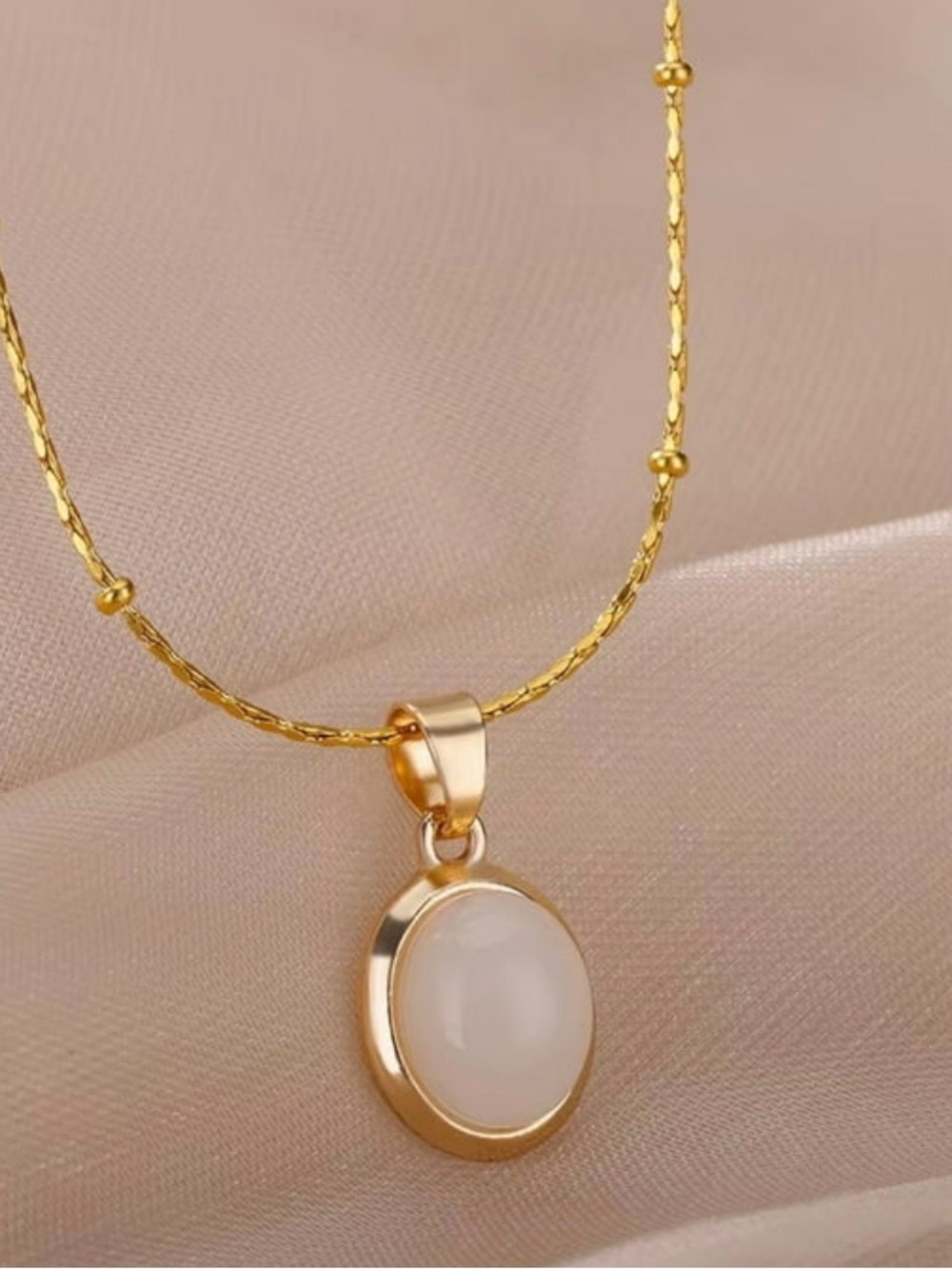 Gold Oval Pendant Necklace with Cream Stone